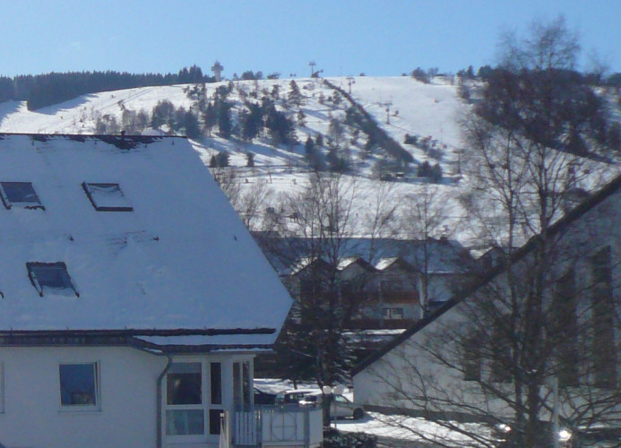 Fewo A**** - Wohnzimmeraussicht auf Skigebiet und Seilbahn